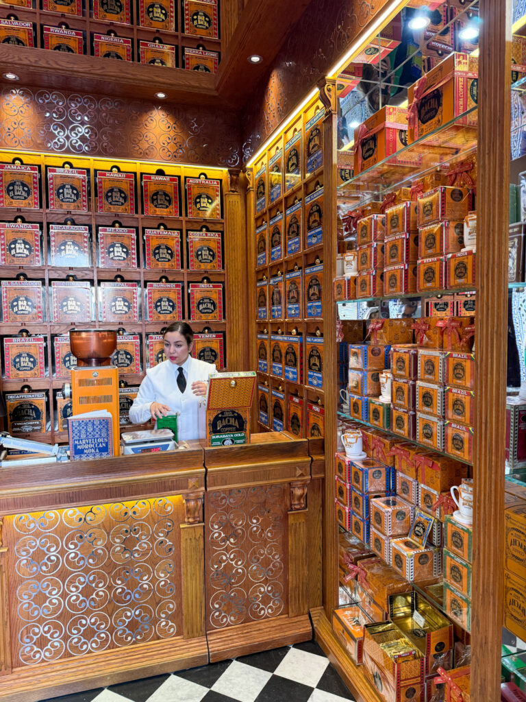 Dar El Bacha Coffee Shop in Marrakech, featuring a luxurious wooden interior with shelves stocked with premium coffee blends.