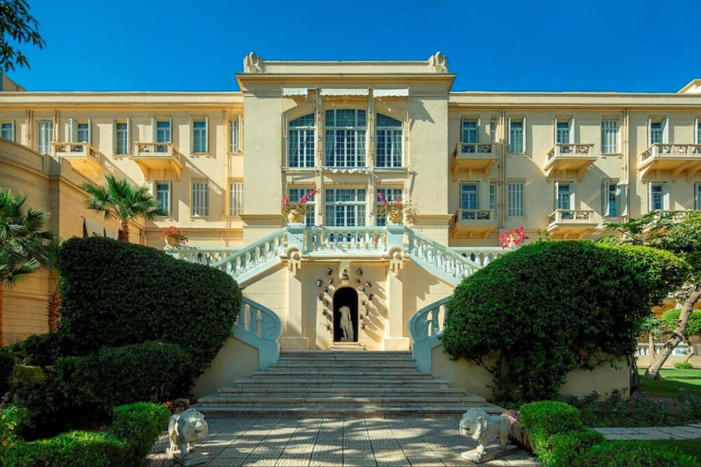 The grand entrance of Sofitel Winter Palace in Luxor, showcasing its classic architecture, lush gardens, and majestic staircases leading to the historic palace.