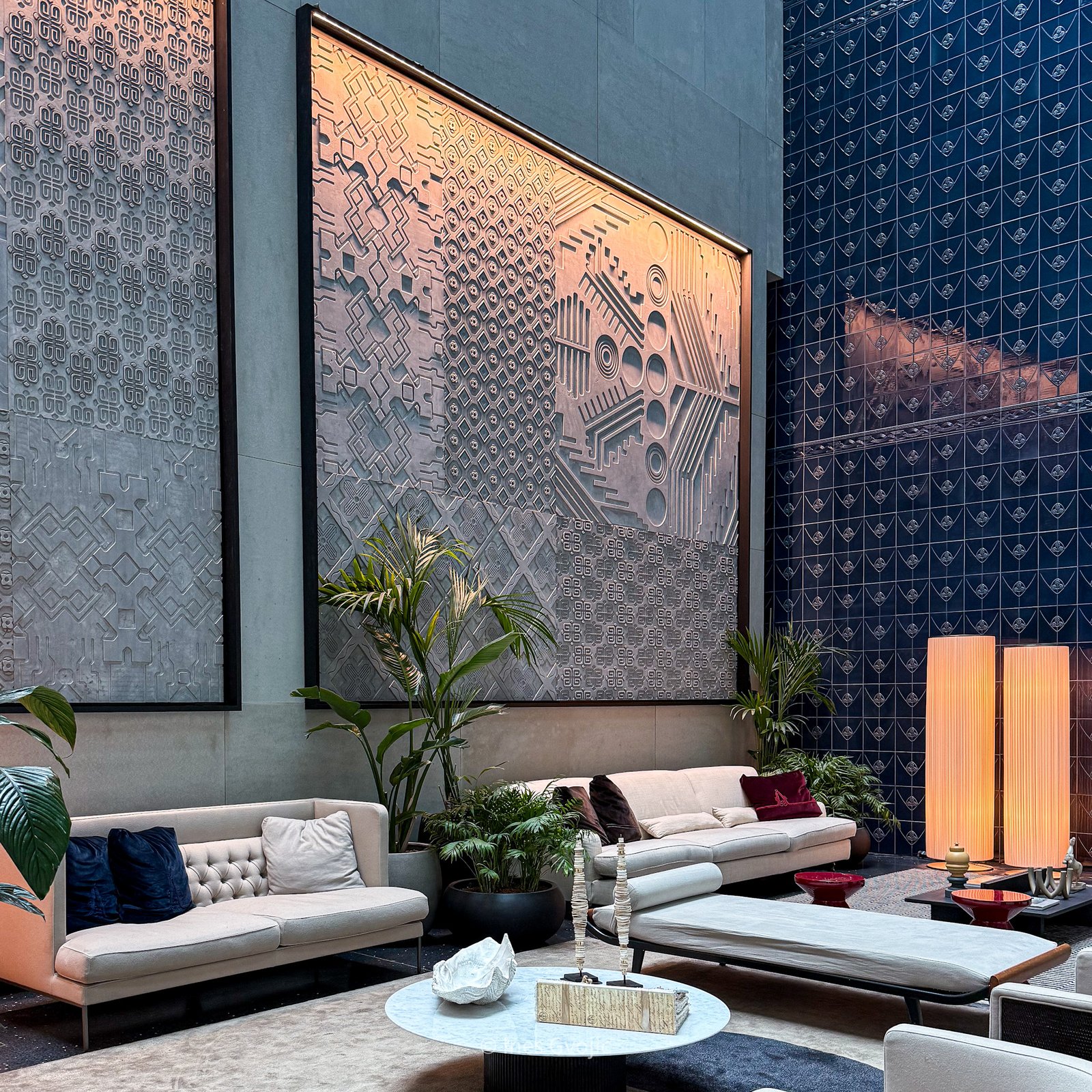 Stylish seating area with wall art inside Dorothea Budapest hotel atrium