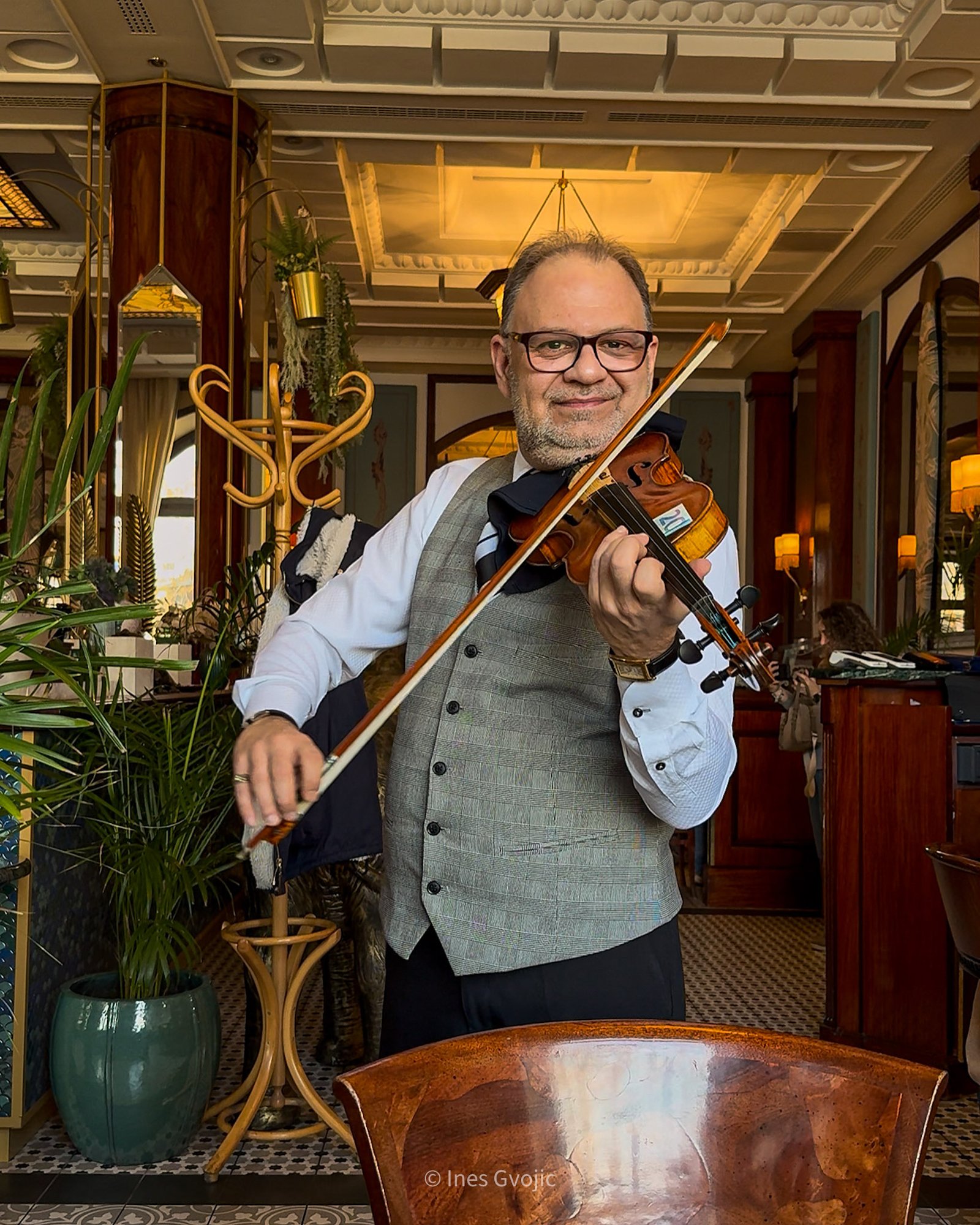 Violinist performing at Gundel Restaurant in Budapest in an elegant indoor setting