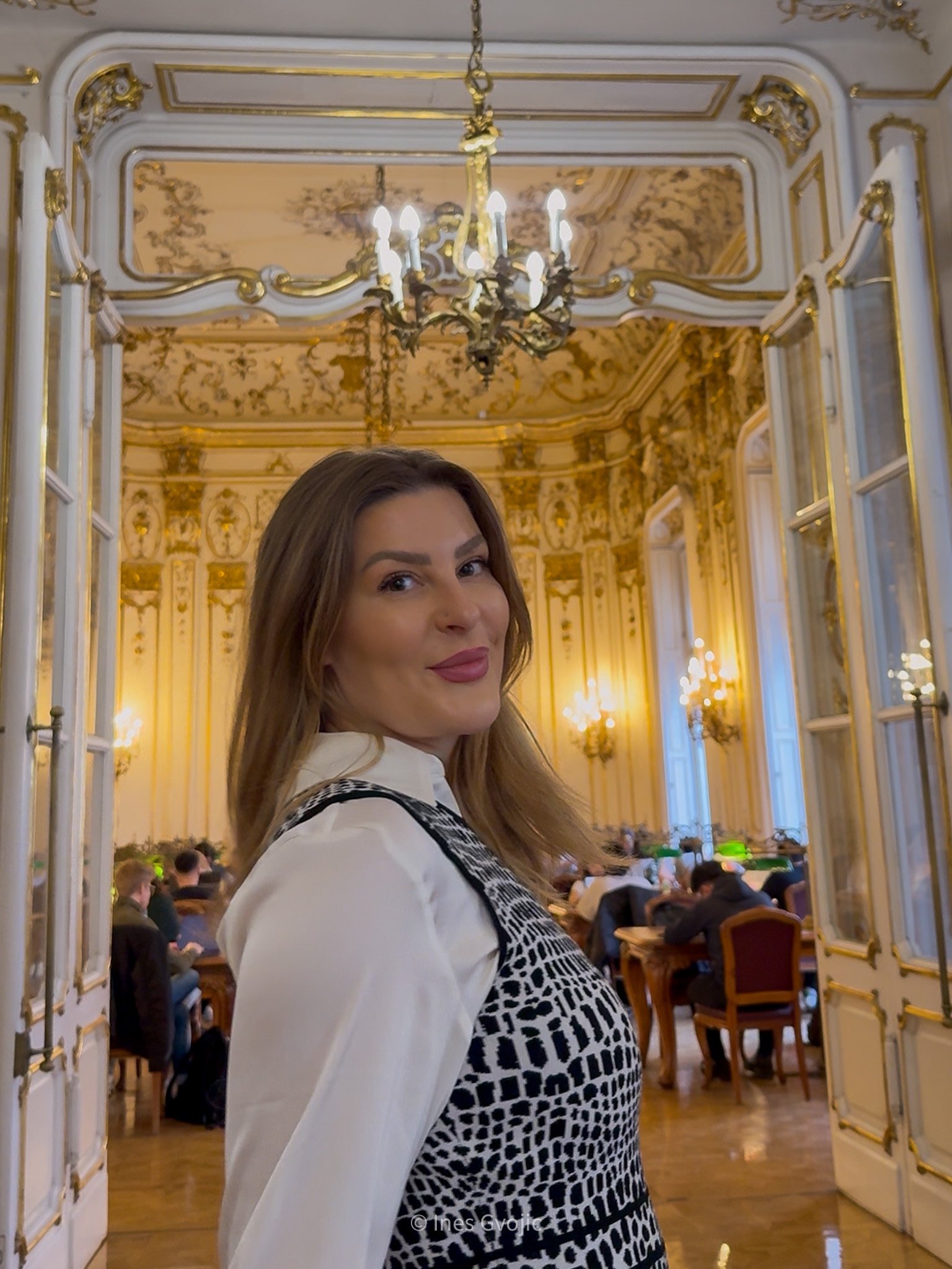 Woman entering ornate baroque-style room in Szabó Ervin Library, Budapest