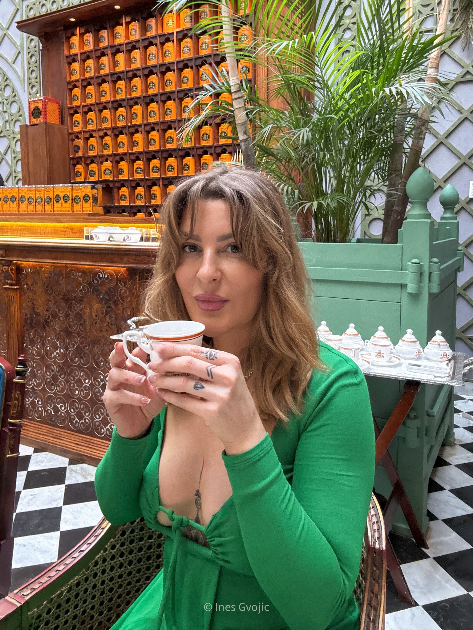 Woman enjoying a cup of coffee at Bacha Coffee in Marrakech, Morocco