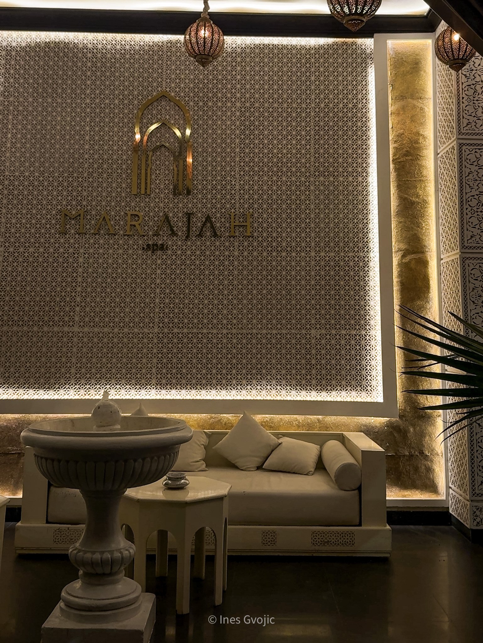 Marajah Spa Marrakech reception area with patterned walls, white fountain, and ambient lighting.